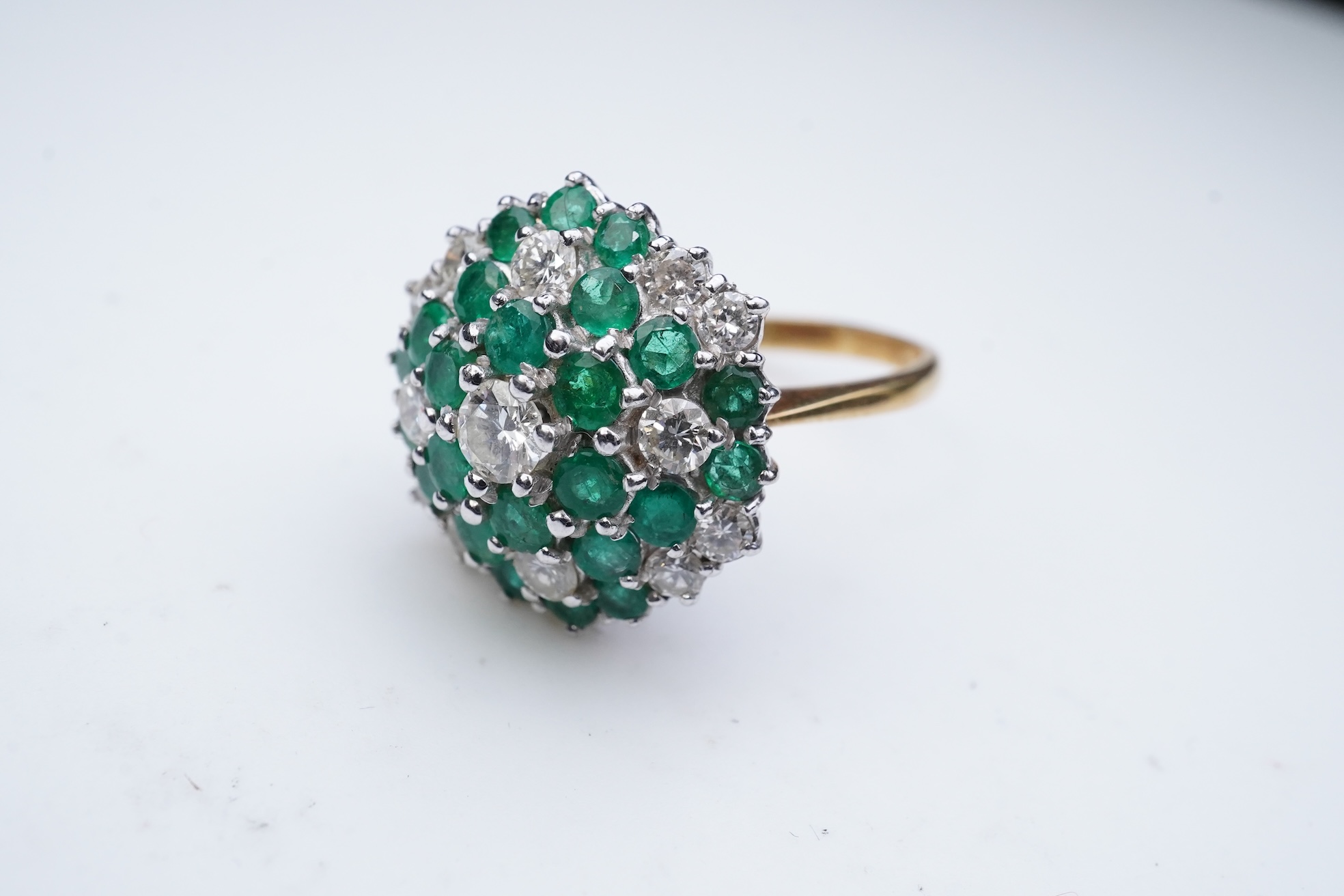 An emerald and diamond cocktail ring